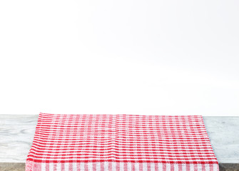 Empty wooden desk table and red checked tablecloth