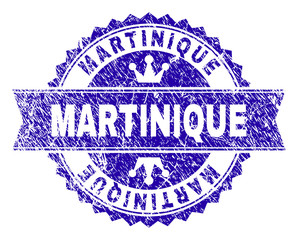 MARTINIQUE rosette seal imprint with grunge texture. Designed with round rosette, ribbon and small crowns. Blue vector rubber watermark of MARTINIQUE text with corroded texture.