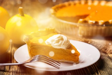 Tasty pumpkin pie on background