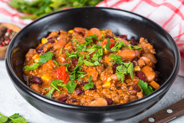 Fototapeta premium Chili con carne from meat and vegetables on stone table close up.