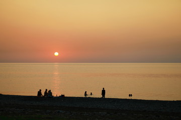 Group of people at sunset on the beach