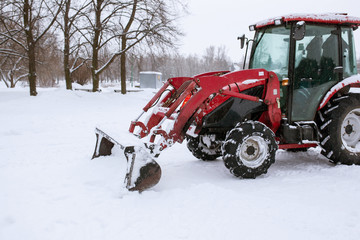 Tractor cleaning snow in a park