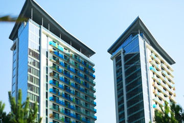 Two similar modern building on blue background