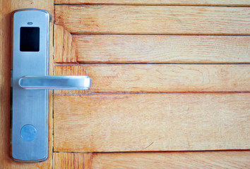 beautiful door handle, on wooden background, close-up