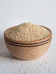 White quinoa in a wooden bowl.
