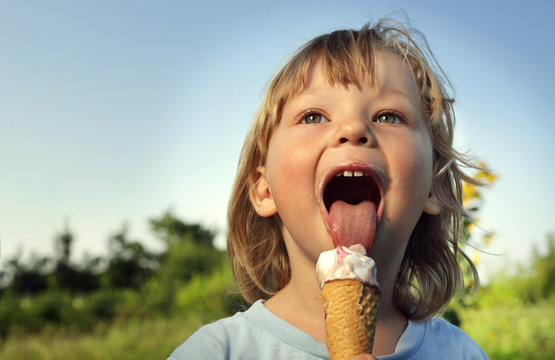 happy little boy eating an ice cream