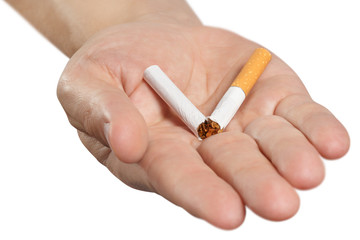 Close-up of a hand holding a cigarette broken in half, isolated on white background