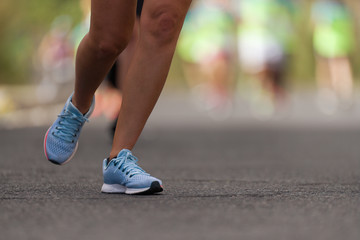 Marathon runners running on city road