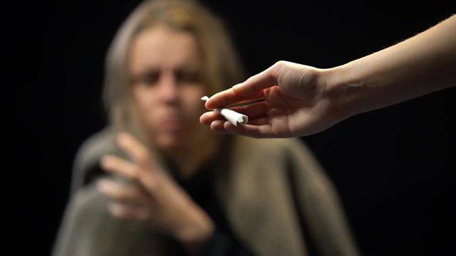Drug addicted female taking marijuana joint from dealer hands, social bottom