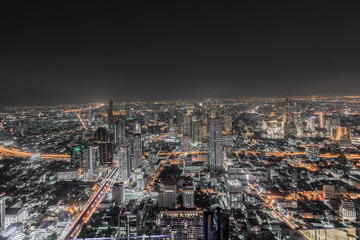 ฺNight scene of Bangkok cityscape with skyscraper and curve of Chao Praya river in the far background with Bokeh effect for nightlife concept / Cityscape concept / Nightlife