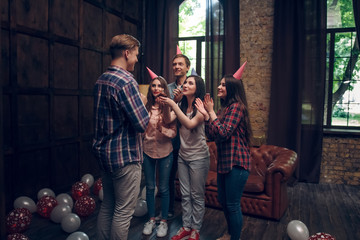 Friends congratulate their friend with birthday cake