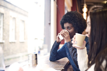 Young black woman and caucasian woman in a cafe