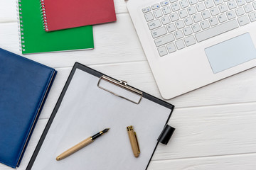 Laptop, diary and dollar banknotes top view