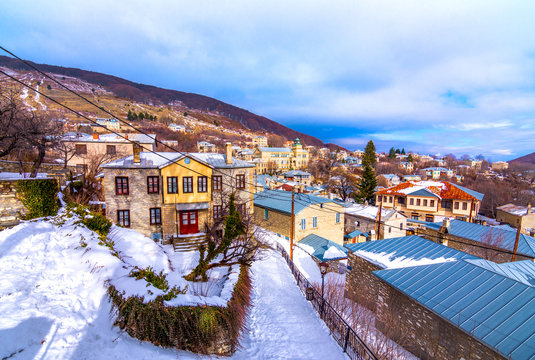 View of traditional stone buildings and streets with snow at the famous village of Nymfaio near Florina, Greece. 