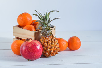 Group of fresh tropical fruits in small wooden box.