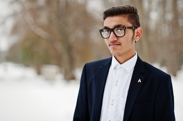 Close up portrait of stylish indian student man in suit and glasses posed at winter day outdoor.