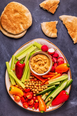 Hummus with various fresh raw vegetables.