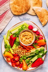 Hummus with various fresh raw vegetables.