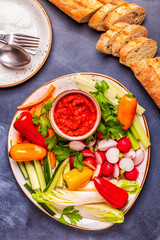 Plate with fresh, raw vegetables and sauce.