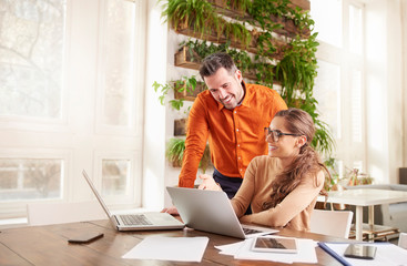 Group of business people working together on laptop in the office