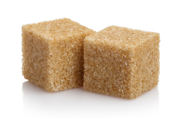 Close-up of two brown sugar cubes, isolated on white background