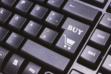 A key that says buy, concept online shopping.