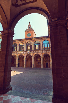 The view through the arch on palace of Archiginnasio in Bologna, Italy from the inner courtyard