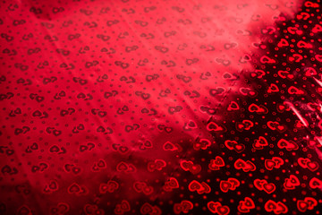 Hologram with hearts, the background on Valentine's Day or a wedding. Background with a pattern in hearts on wrapping paper.