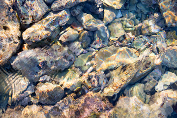 Pebbles of differen sizes in salt water