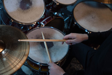 Obraz premium Professional drum set closeup. Drummer with drumsticks playing drums and cymbals, on the live music rock concert or in recording studio 