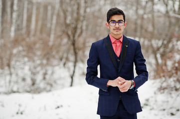 Stylish indian student man in suit and glasses posed at winter day outdoor.