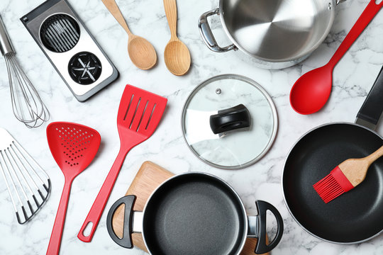 Flat lay composition with clean cookware on marble background