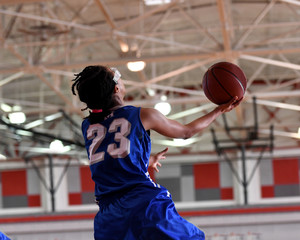 High School athlete making a layup during a basketball game
