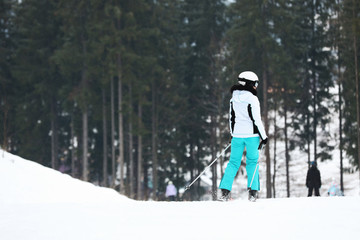 Skier on slope at resort, space for text. Winter vacation