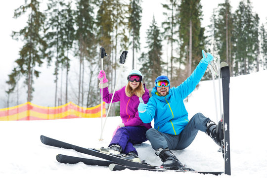 Couple of skiers on slope at resort. Winter vacation