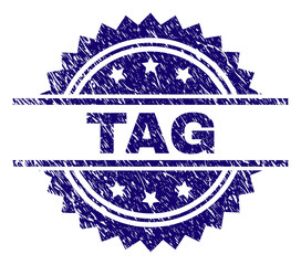 TAG stamp seal watermark with distress style. Blue vector rubber print of TAG text with unclean texture.