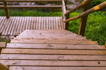 Fototapeta na wymiar Colorful Photo of the Park on a Sunny Autumn day - Closeup of Wooden Path Steps