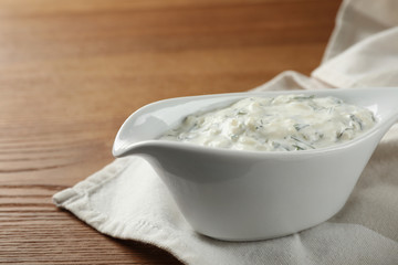 Cucumber sauce on wooden background. Traditional Tzatziki