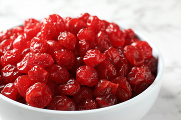 Bowl of sweet cherries on marble background, closeup. Dried fruit as healthy snack