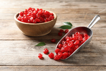Scoop and bowl of sweet cherries on wooden background. Dried fruit as healthy snack
