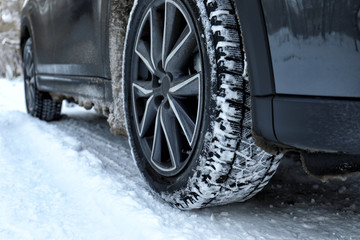 Snowy country road with car on winter day, closeup