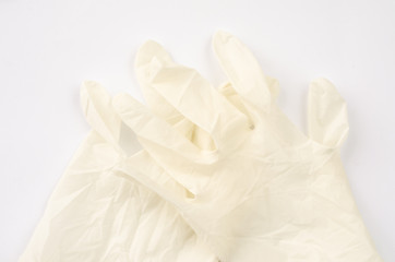 Medical glove and bandage on a white background.