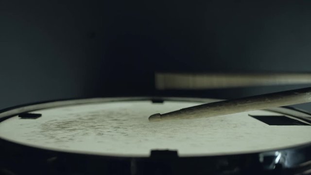 close-up - the drummer plays with sticks on a snare drum, home lesson training