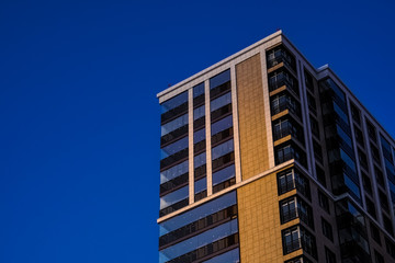Obraz premium The delightful architecture of the city against the blue sky. Bright facades of buildings. New design solutions. 