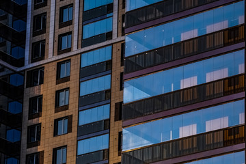 Obraz premium The delightful architecture of the city against the blue sky. Bright facades of buildings. New design solutions. 
