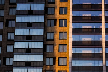 Obraz premium The delightful architecture of the city against the blue sky. Bright facades of buildings. New design solutions. 