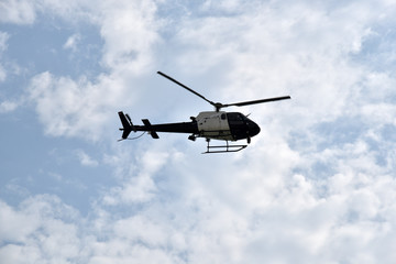 Black helicopter in the sky