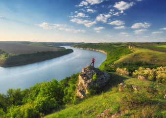 tourist on the rock. girl meditates on nature. canyon of the picturesque river