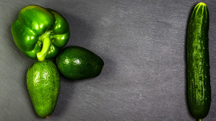 Raw healthy food clean eating vegetables on a grey stone background. Copy space Top view