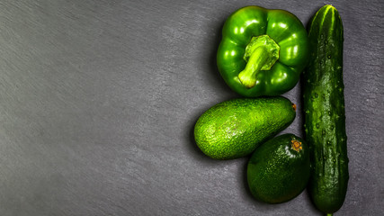 Frame from fresh green vegetables flat lay with free space for text